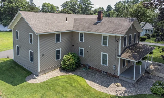 a aerial view of a house with yard and sitting area