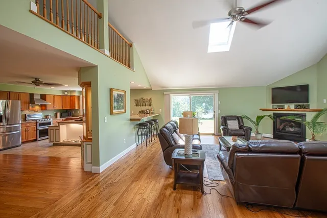 a living room with fireplace furniture and a wooden floor
