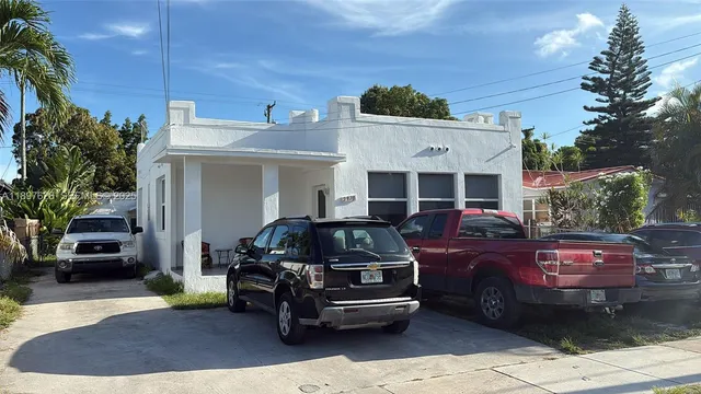 a front view of a house with parking space