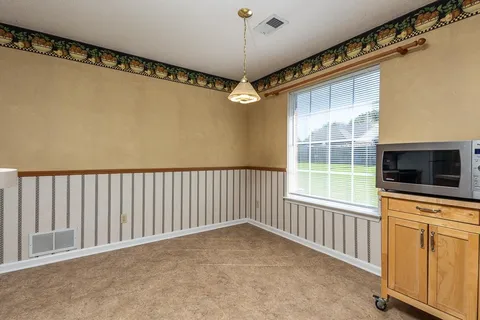 a view of a livingroom with an empty space and a window