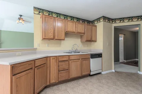a kitchen with cabinets a sink and a window