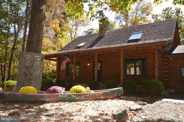 a front view of a house with a yard covered in snow