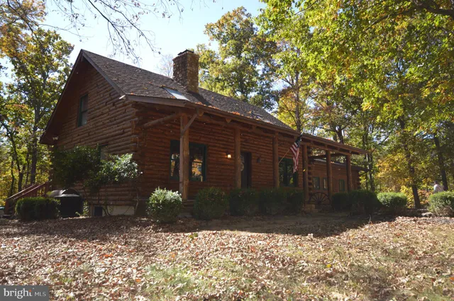 a living room with hard wood floors and a fireplace