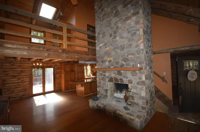 a view of living room with furniture and a fireplace
