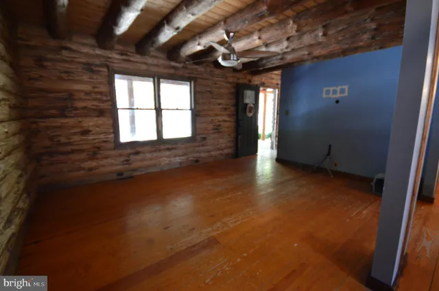 a view of an empty room with windows