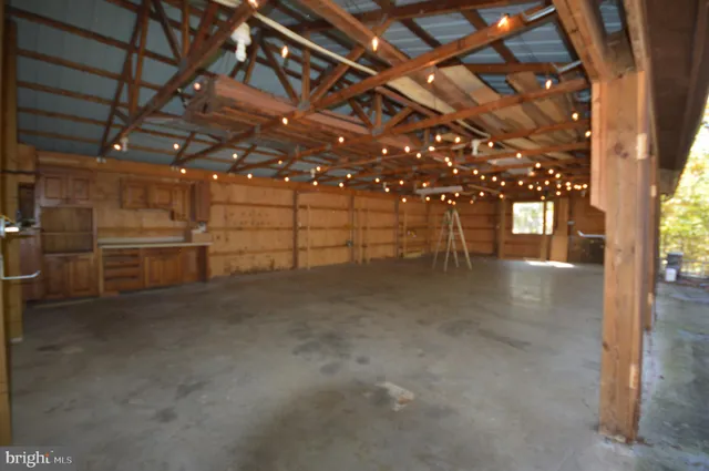 a view of a swimming pool with lawn chairs and plants