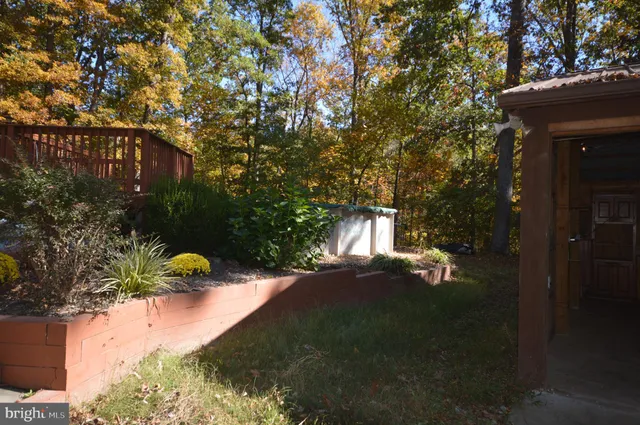 a backyard of a house with table and chairs and a fire pit