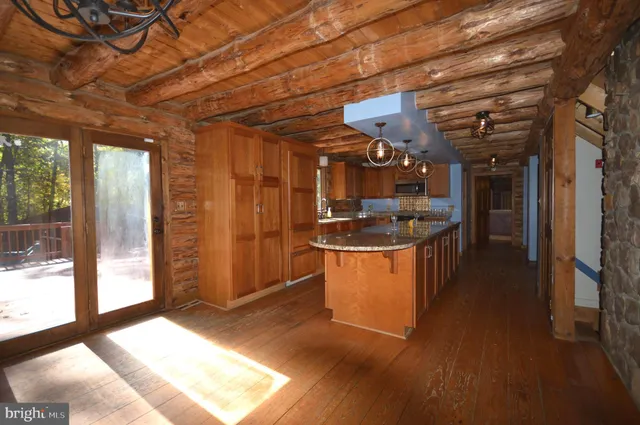 a kitchen with stainless steel appliances kitchen island granite countertop a stove a sink and a refrigerator