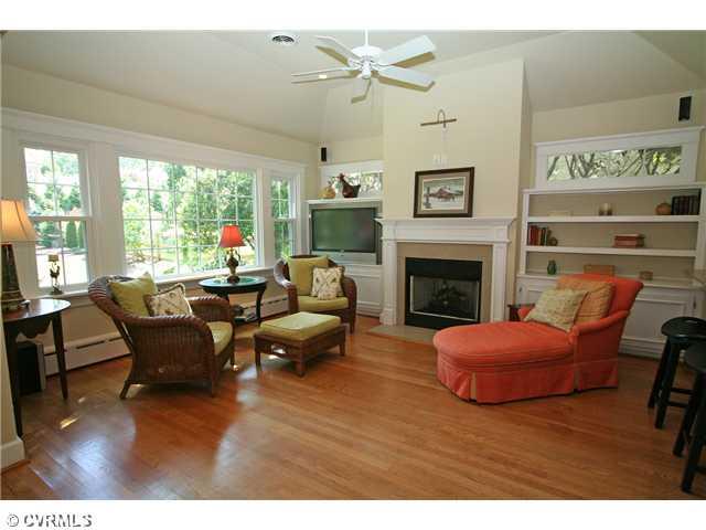 6005 Howard Road Richmond, VA 23226 - Photo 9 of 24 Den/Family/Great Room - Gas fireplace flanked by built-in bookshelves with transomed windows above and cabinetry below.