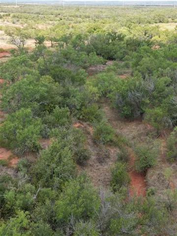 a view of a field with an ocean view
