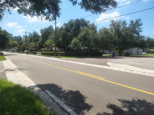 a view of a tennis court with trees in the background