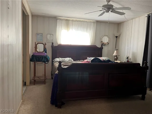 a bedroom with bed and window