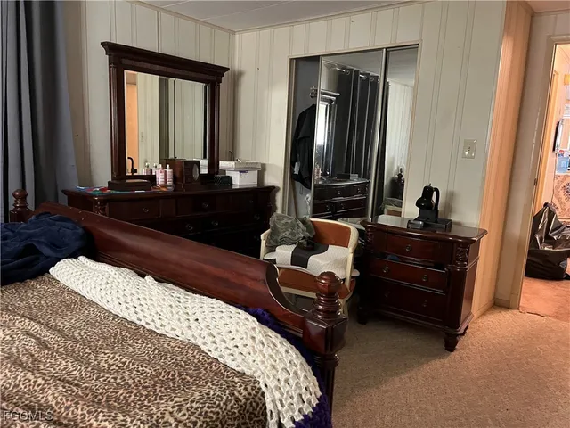 a bedroom with a bed and a mirror