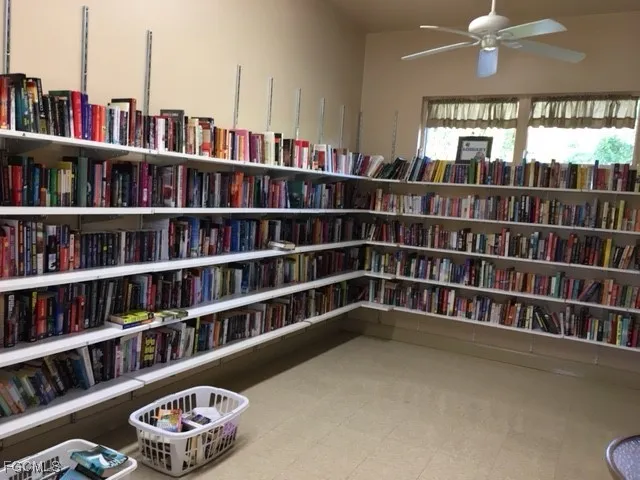 a living room with hard wood shelves and a book shelf