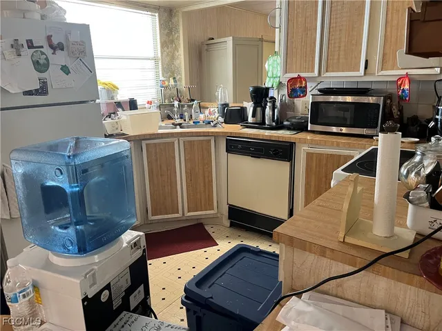 a kitchen with a sink appliances and cabinets