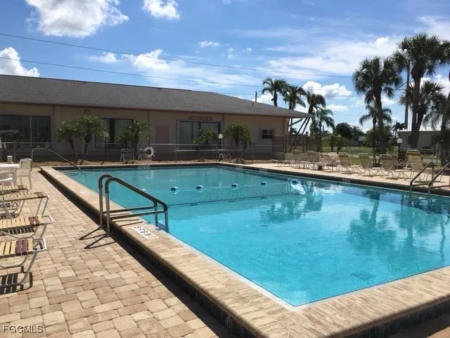 a view of swimming pool with chairs