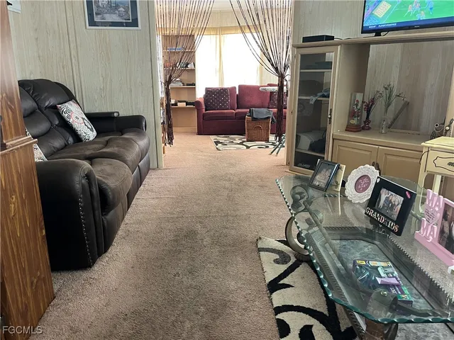 a living room with furniture a window and gym equipment