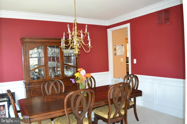 a view of a dining room with furniture and chandelier