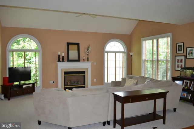 a living room with fireplace furniture and a flat screen tv
