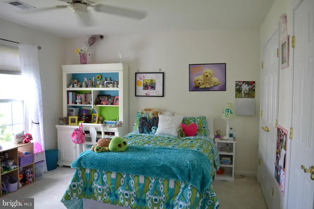 a bedroom with furniture a baby crib and a window