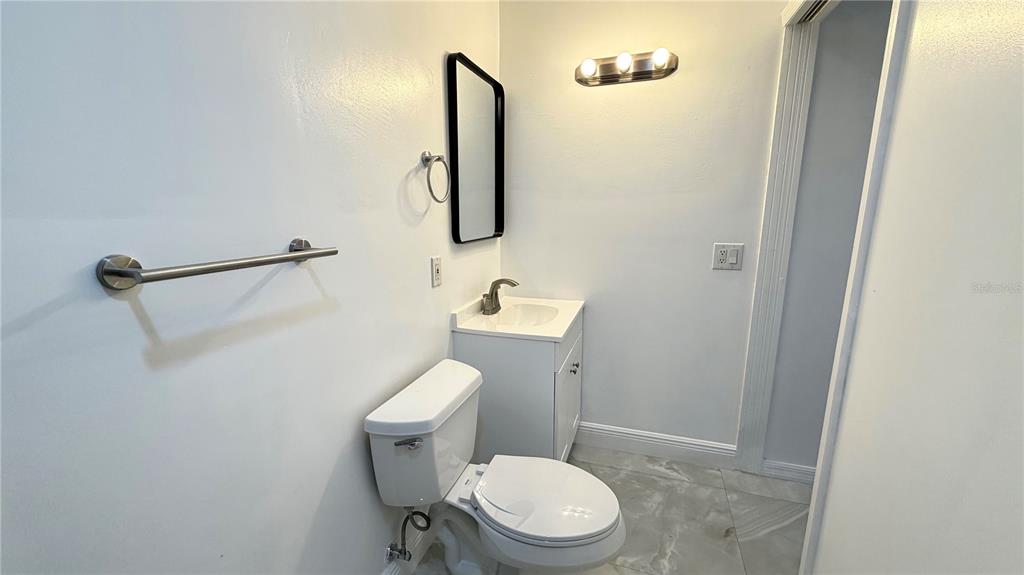 6310 Lake Underhill Road, Unit B Orlando, FL 32807 - Photo 8 of 8 a white toilet sitting next to a bathroom sink