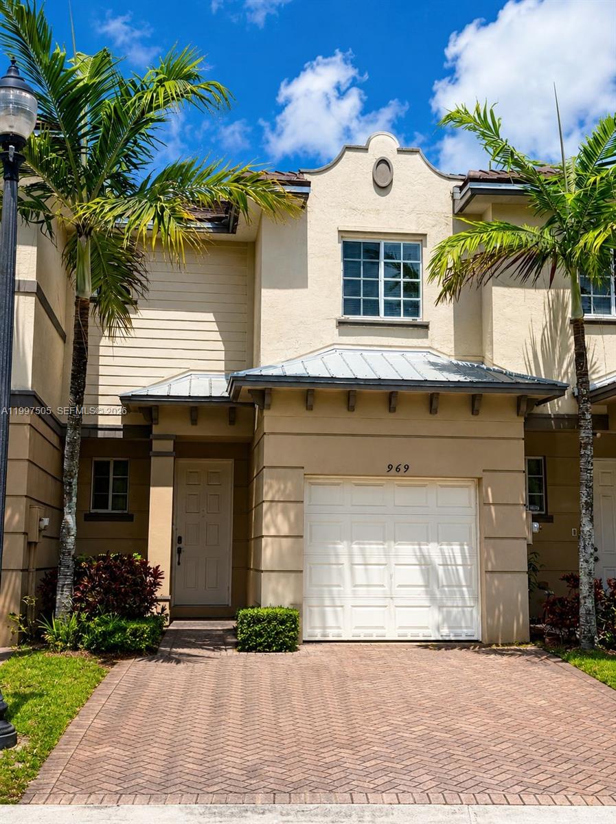 a front view of a house with a yard and garage