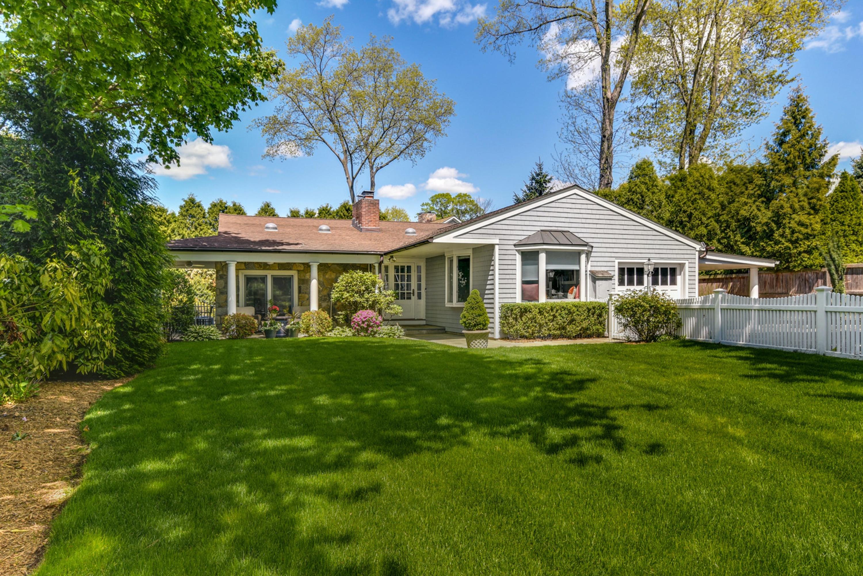 a front view of a house with a garden