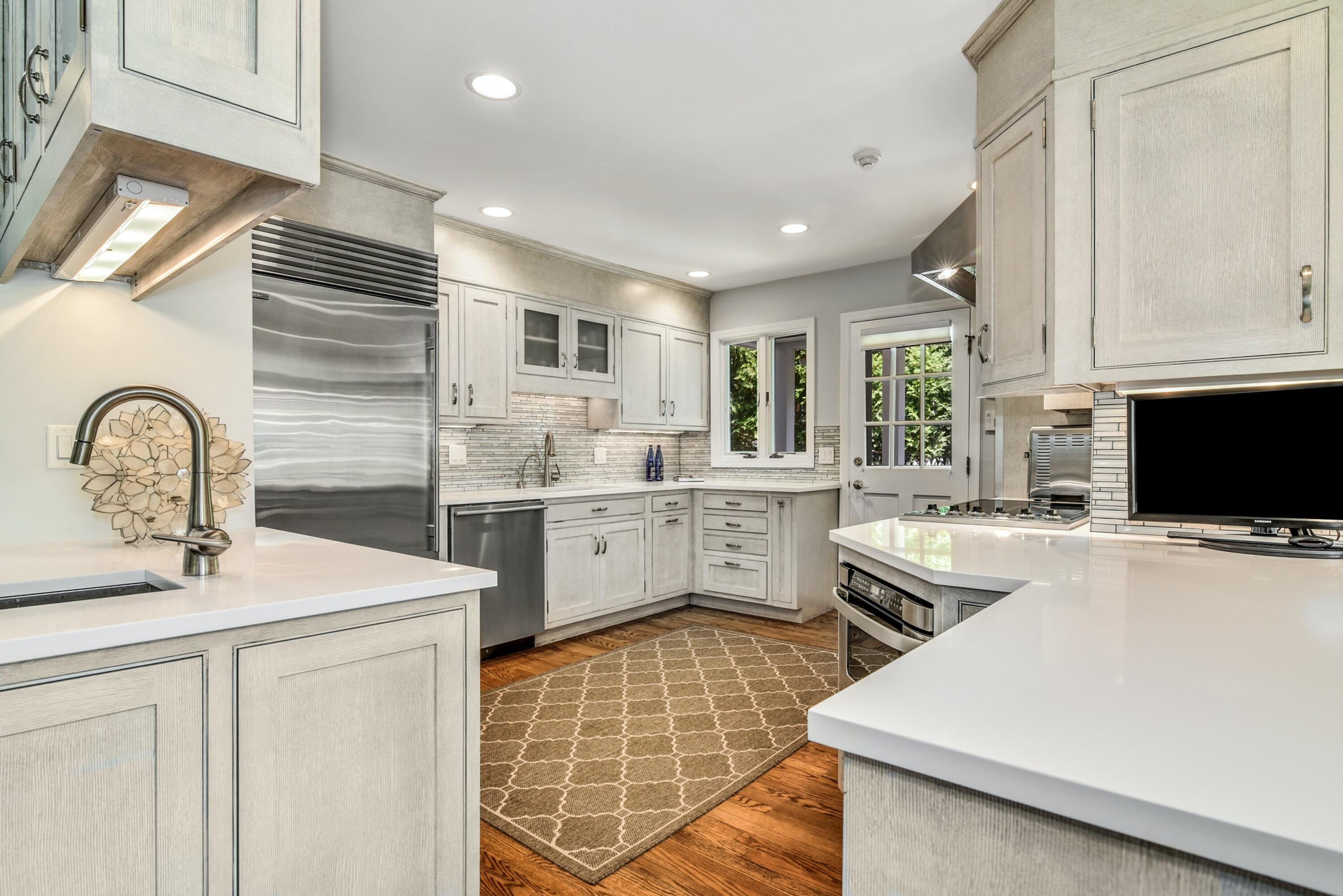 9 Top Sail Road Rowayton, CT 06853 - Photo 13 of 30 a kitchen that has a sink stainless steel appliances and cabinets