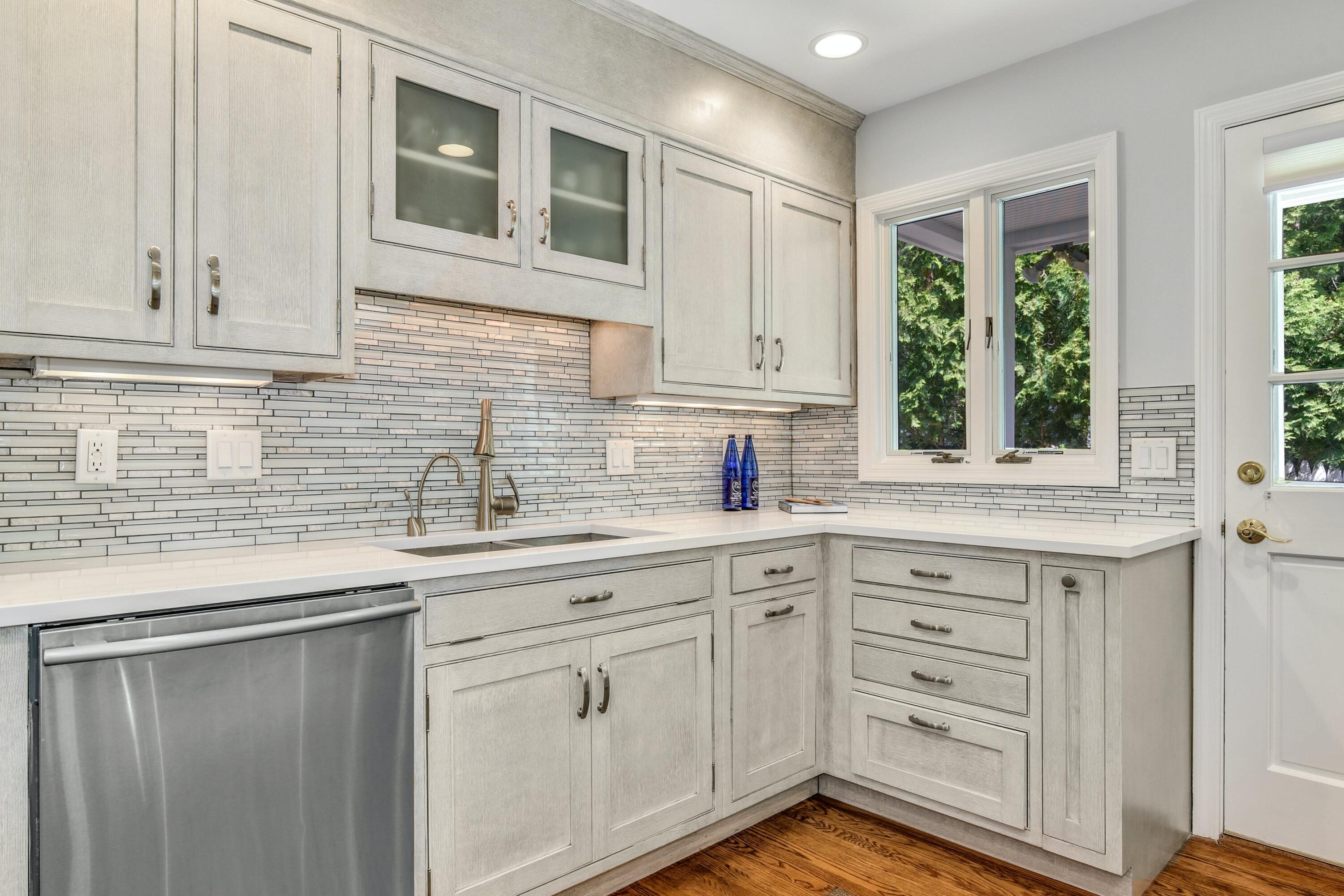 9 Top Sail Road Rowayton, CT 06853 - Photo 14 of 30 a kitchen with white cabinets and window