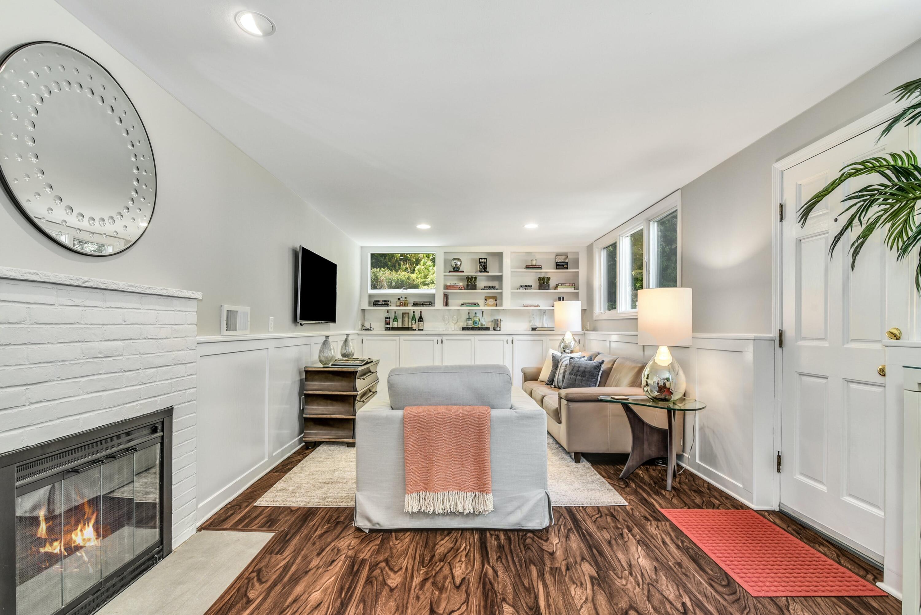 9 Top Sail Road Rowayton, CT 06853 - Photo 16 of 30 a living room with furniture a fireplace and a flat screen tv