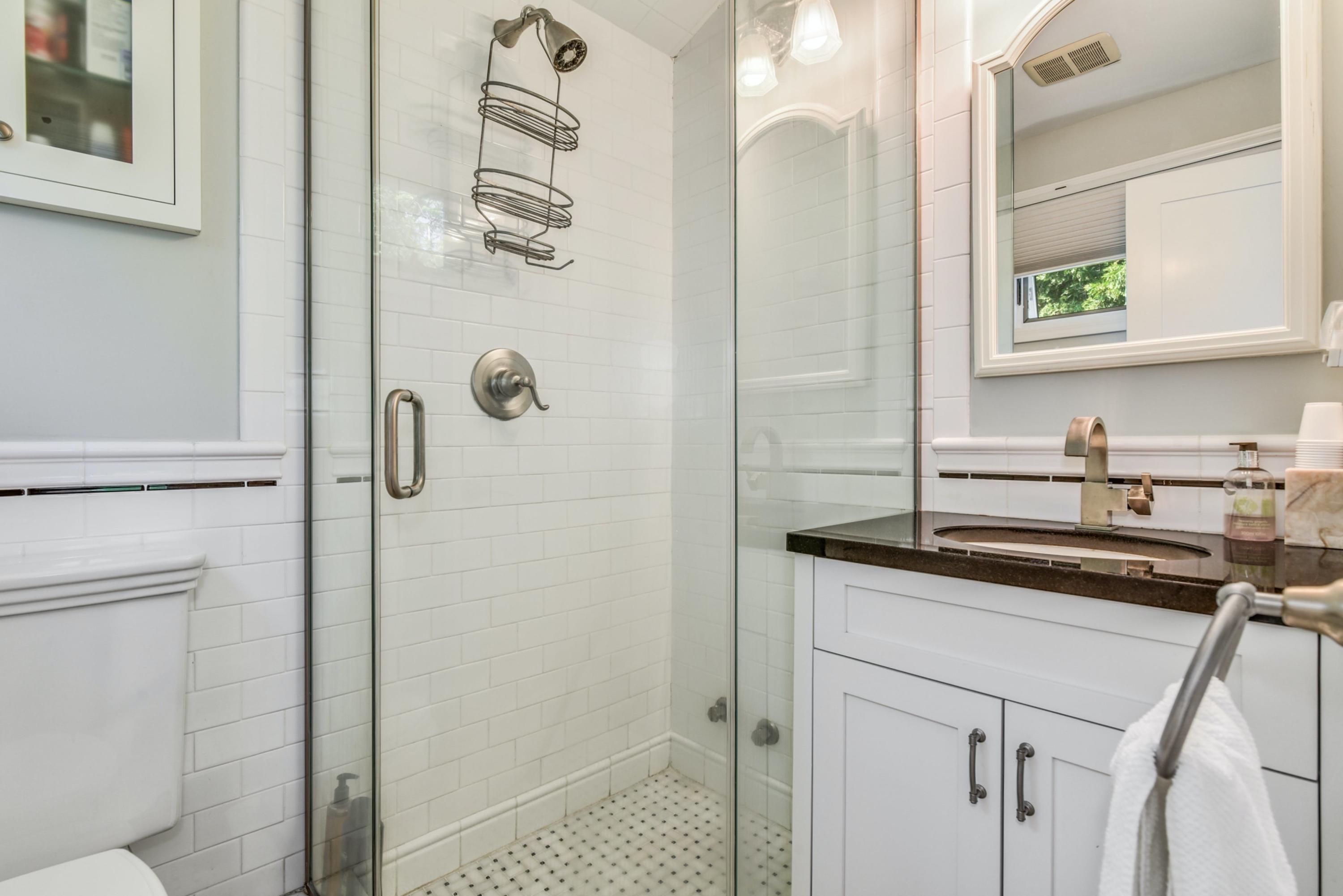 9 Top Sail Road Rowayton, CT 06853 - Photo 27 of 30 a bathroom with a granite countertop sink a mirror and shower