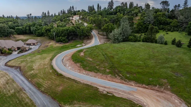 an aerial view of residential house with green space