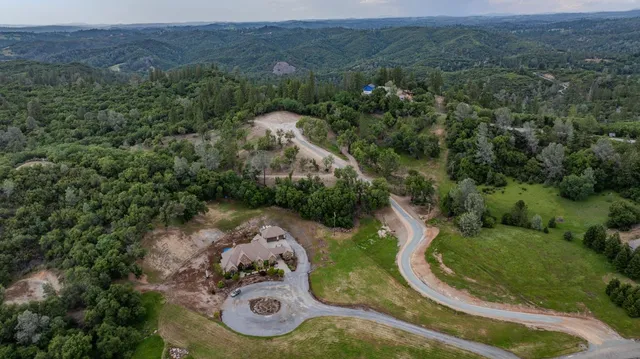 an aerial view of a house with a yard