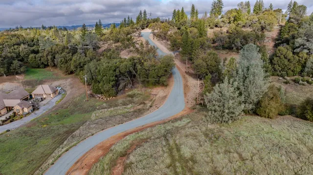an aerial view of a house with outdoor space and a lake view
