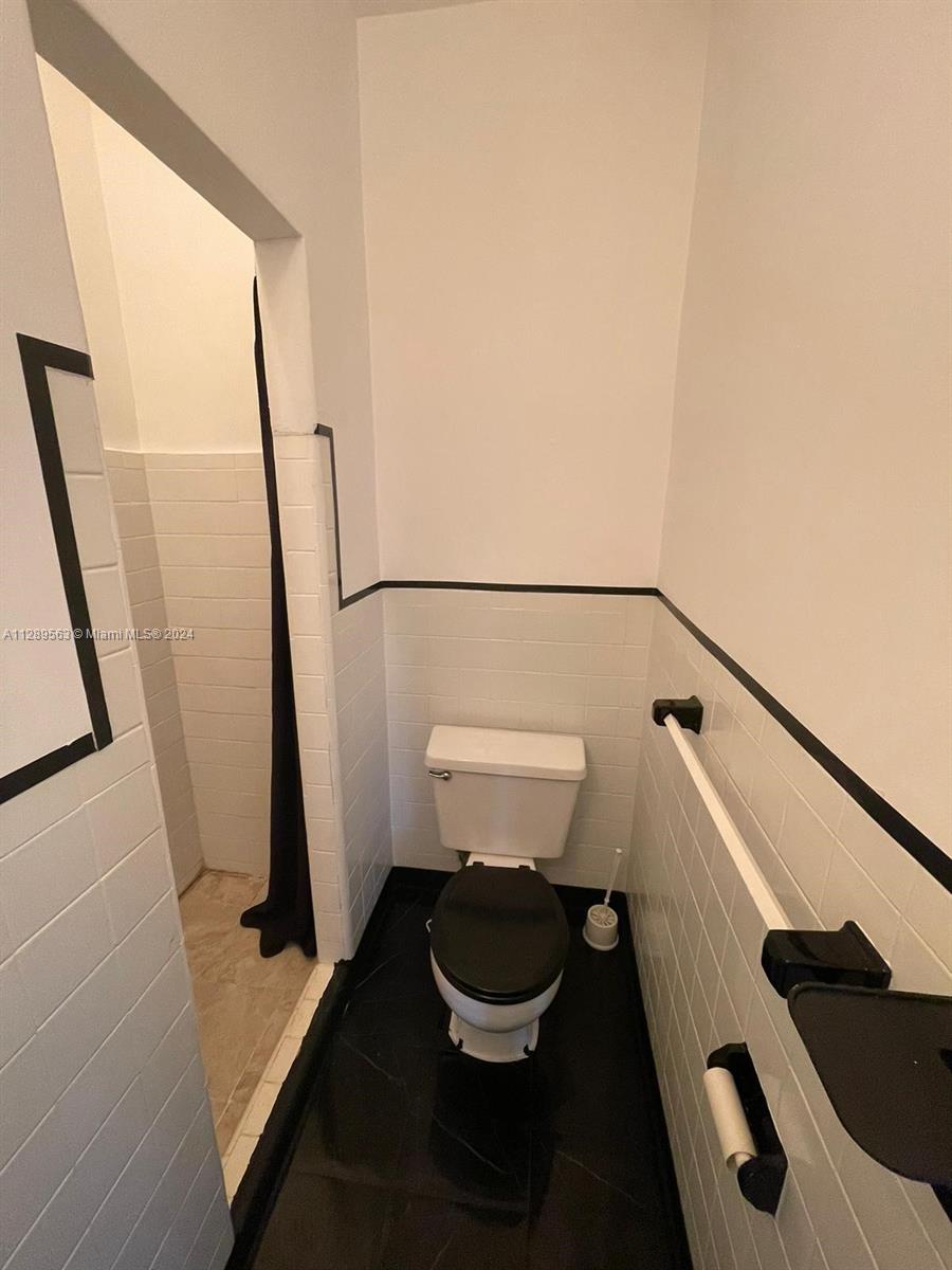 1455 Michigan Avenue, Unit 7 Miami Beach, FL 33139 - Photo 8 of 12 a bathroom with a sink and toilet