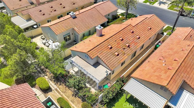 an aerial view of multiple houses with yard