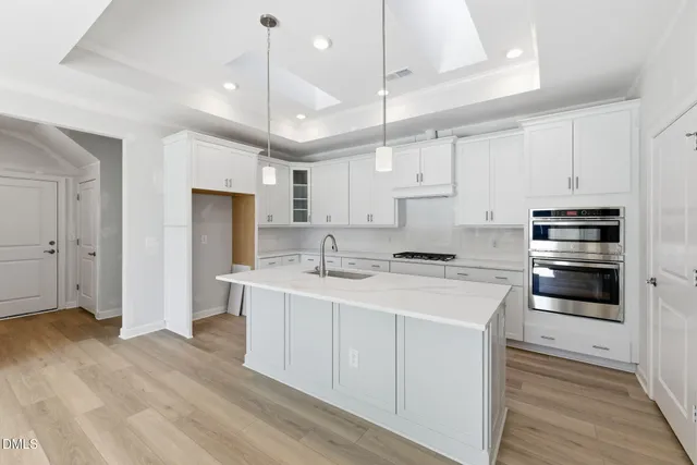 a kitchen with a sink stainless steel appliances and cabinets