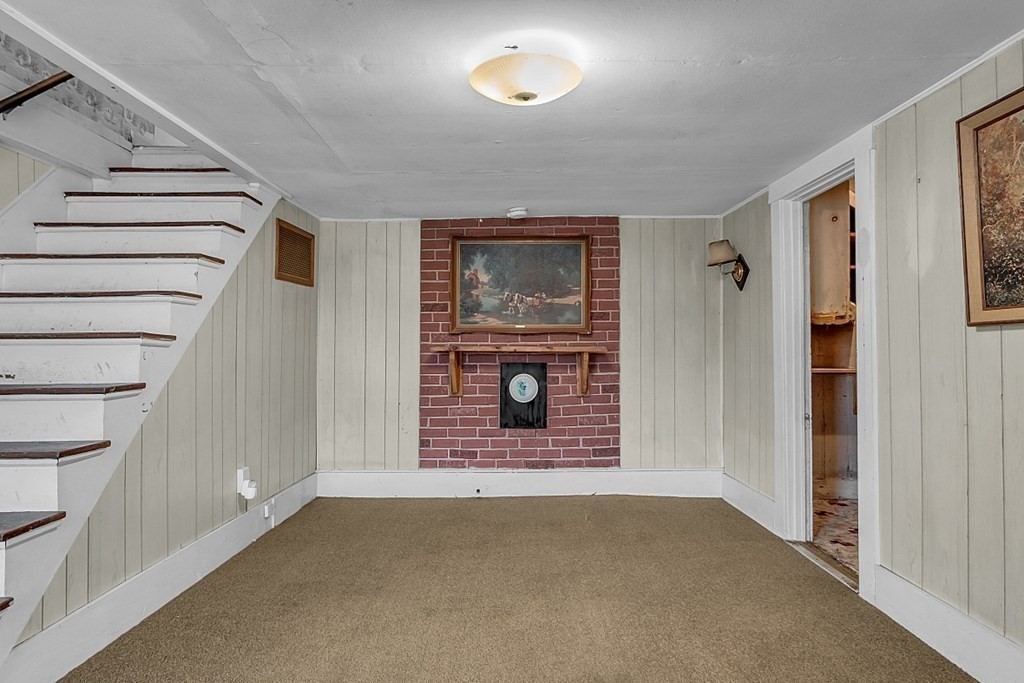 369 Old Northfield Road Ashby, MA 01431 - Photo 8 of 24 a view of an empty room with wooden floor and stairs