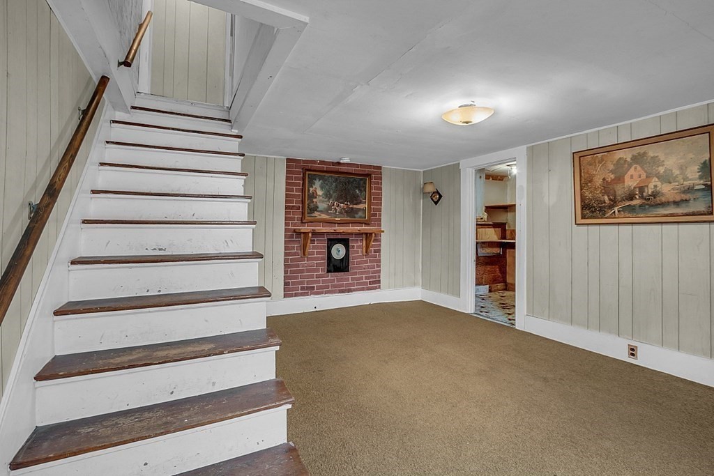 369 Old Northfield Road Ashby, MA 01431 - Photo 9 of 24 a view of an empty room with stairs and a window