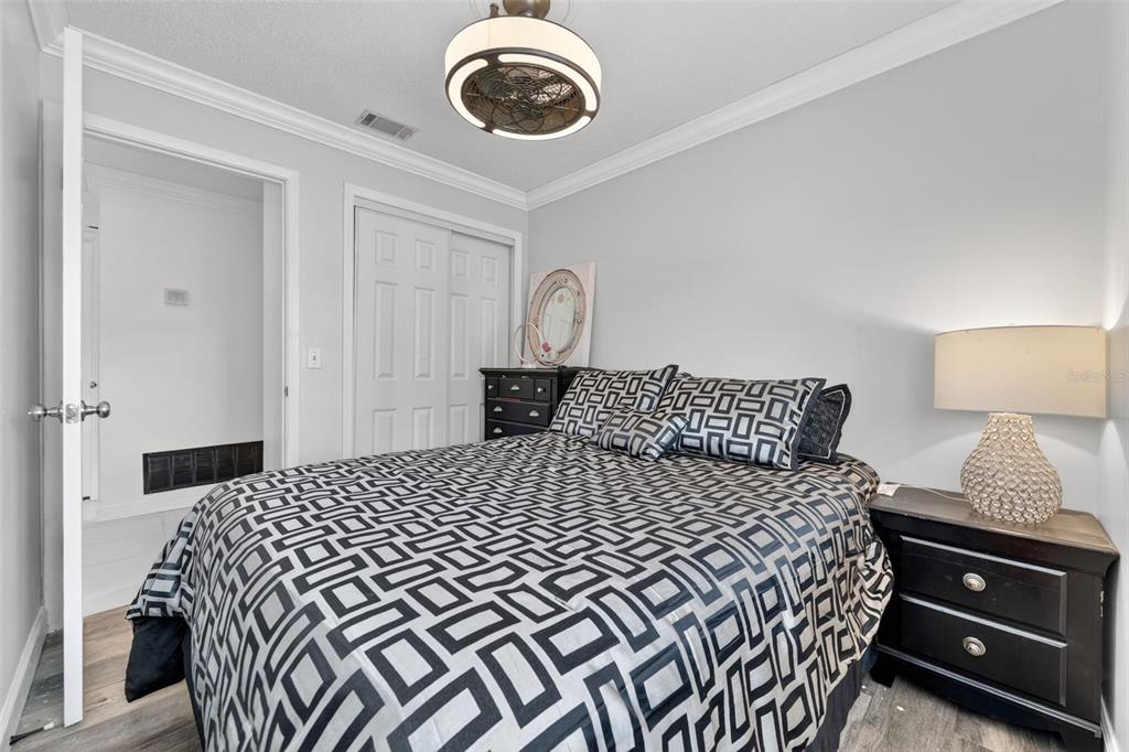 575 Tiberon Cove Road Longwood, FL 32750 - Photo 25 of 56 a bedroom with a bed and a lamp