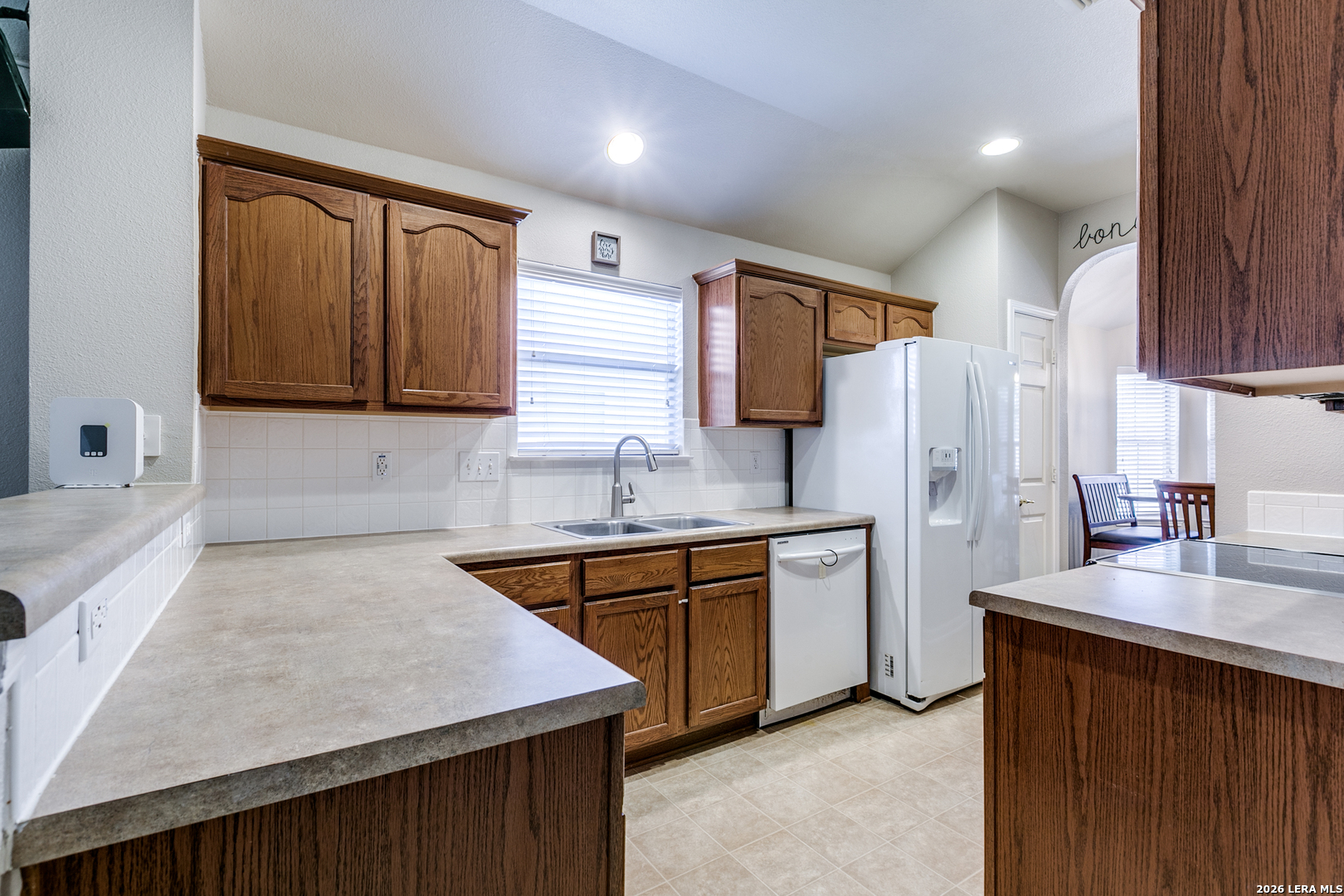 6822 Freedom Ridge San Antonio, TX 78242 - Photo 13 of 25 a kitchen with stainless steel appliances granite countertop refrigerator sink and cabinets