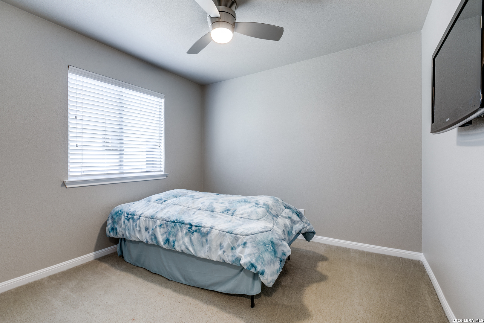 6822 Freedom Ridge San Antonio, TX 78242 - Photo 18 of 25 a bedroom with a bed and a flat tv screen