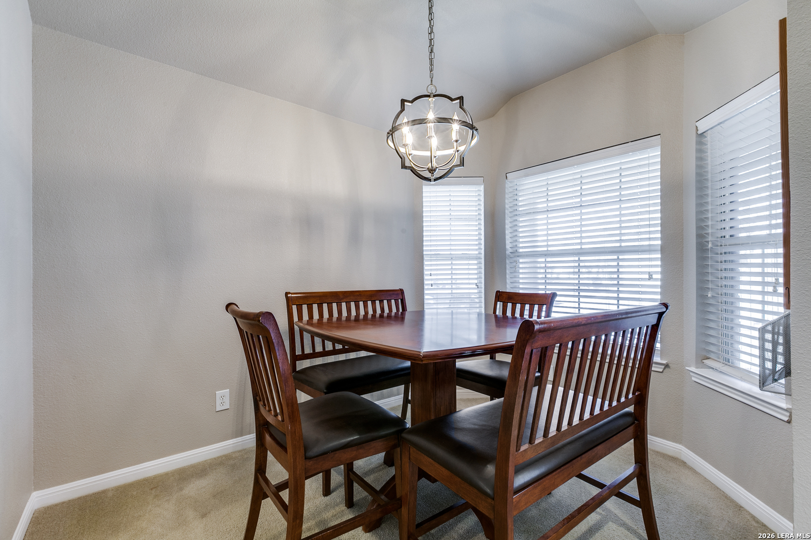 6822 Freedom Ridge San Antonio, TX 78242 - Photo 6 of 25 a view of a dining room with furniture wooden floor and a window