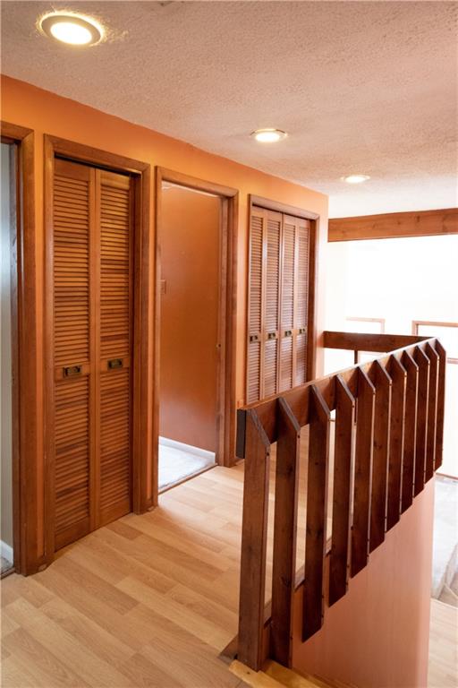 3380 Ridgway Street Pittsburgh, PA 15213 - Photo 18 of 25 Upper level landing including a view of the third bedroom's doorway and just a few of the many closets available. Stairs lead down to the living and dining rooms. The front of the house is to the right; back of the house is to the left.