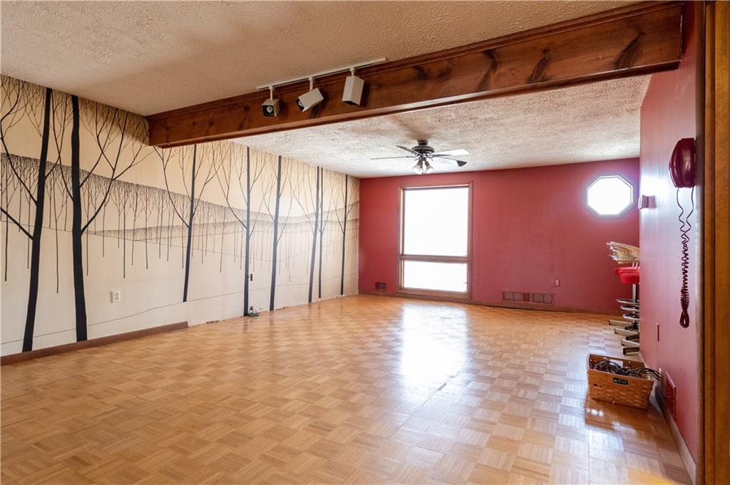 3380 Ridgway Street Pittsburgh, PA 15213 - Photo 19 of 25 Large additional room located on the main level as viewed from the family room. Window looks out onto the front yard and Ridgeway Street. Master bed and bath is located just above. This floor is made for dancing; wet bar to the right.