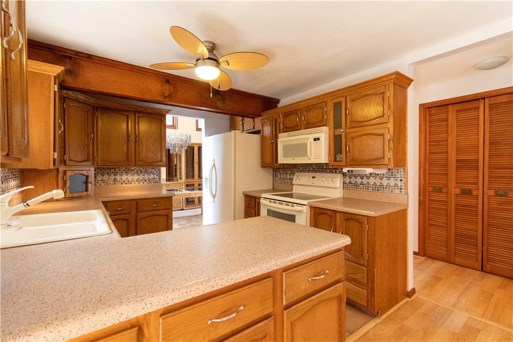 3380 Ridgway Street Pittsburgh, PA 15213 - Photo 2 of 25 Fully equipped kitchen as viewed from the family room and/or sunroom. Dining room is visible through doorway next to refrigerator. Half bath located just out of frame, to the right.