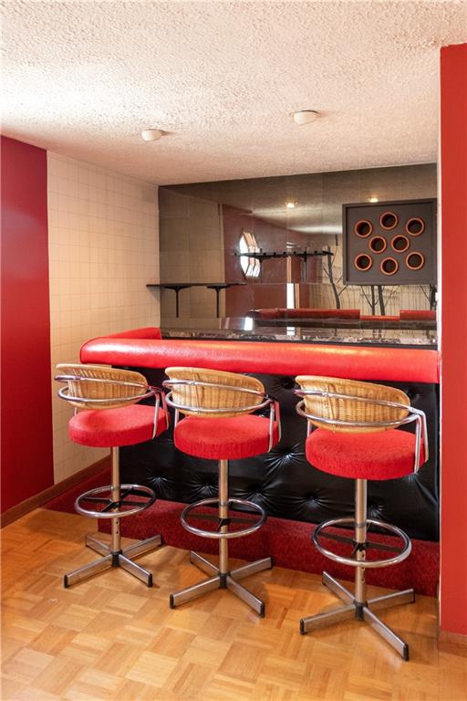 3380 Ridgway Street Pittsburgh, PA 15213 - Photo 21 of 25 The wet bar with three seats and mirrored wall.