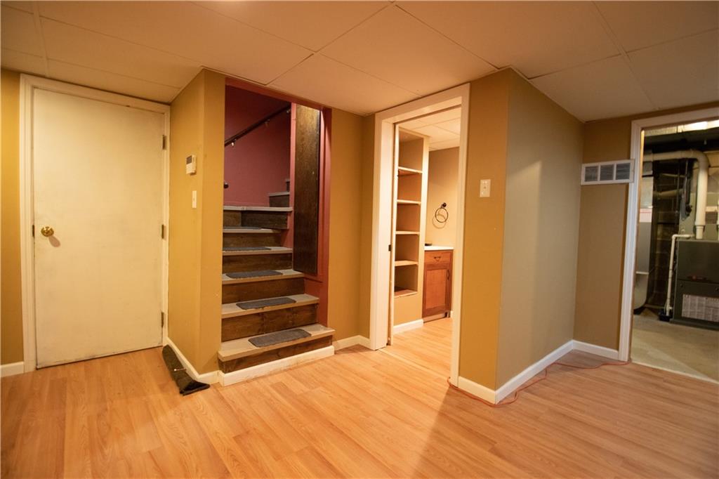 3380 Ridgway Street Pittsburgh, PA 15213 - Photo 24 of 25 Lower level landing including a view of the second half bath, entry to the the garage (door on the left), stairs to main level and entry to the laundry room (doorway on the right). Additional storage rooms are located further left of the garage entrance.