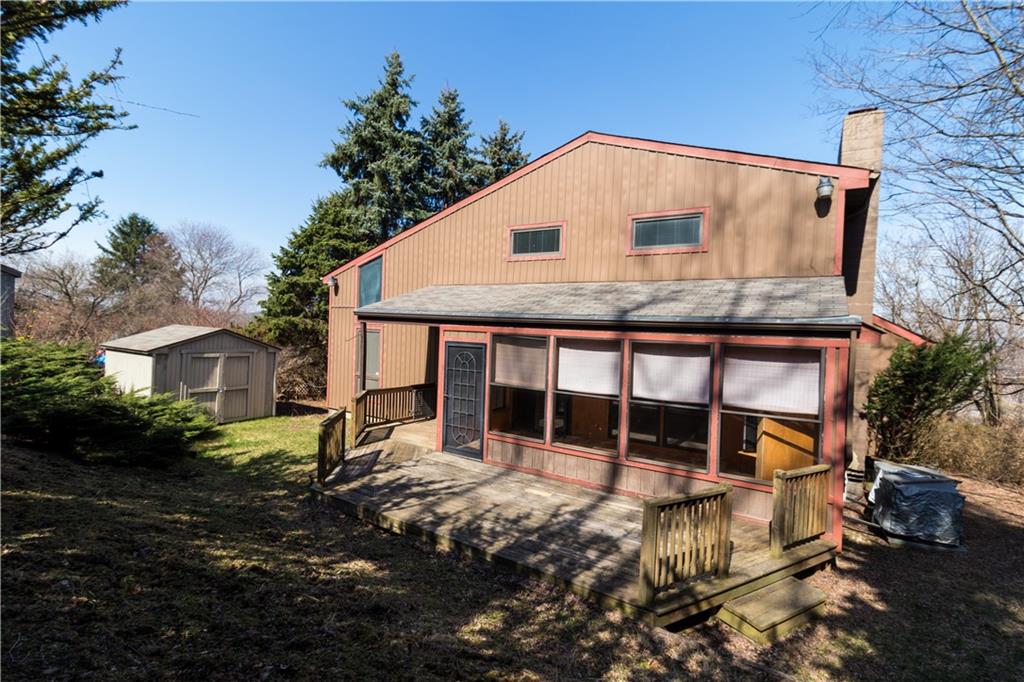 3380 Ridgway Street Pittsburgh, PA 15213 - Photo 25 of 25 Back view of 3380 Ridgway Street including backyard, wooden deck, sunroom and storage shed. Upper level windows are to the second and third bedrooms.