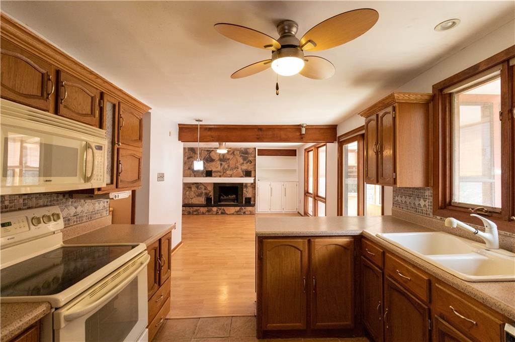 3380 Ridgway Street Pittsburgh, PA 15213 - Photo 3 of 25 Kitchen and family room as viewed from the dining room doorway. Backyard viewed through window above sink. Sunroom to the right.